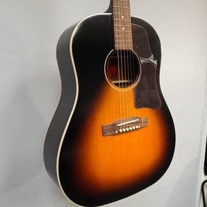 Epiphone Masterbilt J-45 acoustic guitar, Aged Vintage Sunburst Gloss, displayed close-up, showcasing its solid wood construction and distinctive 60s Kalamazoo headstock.