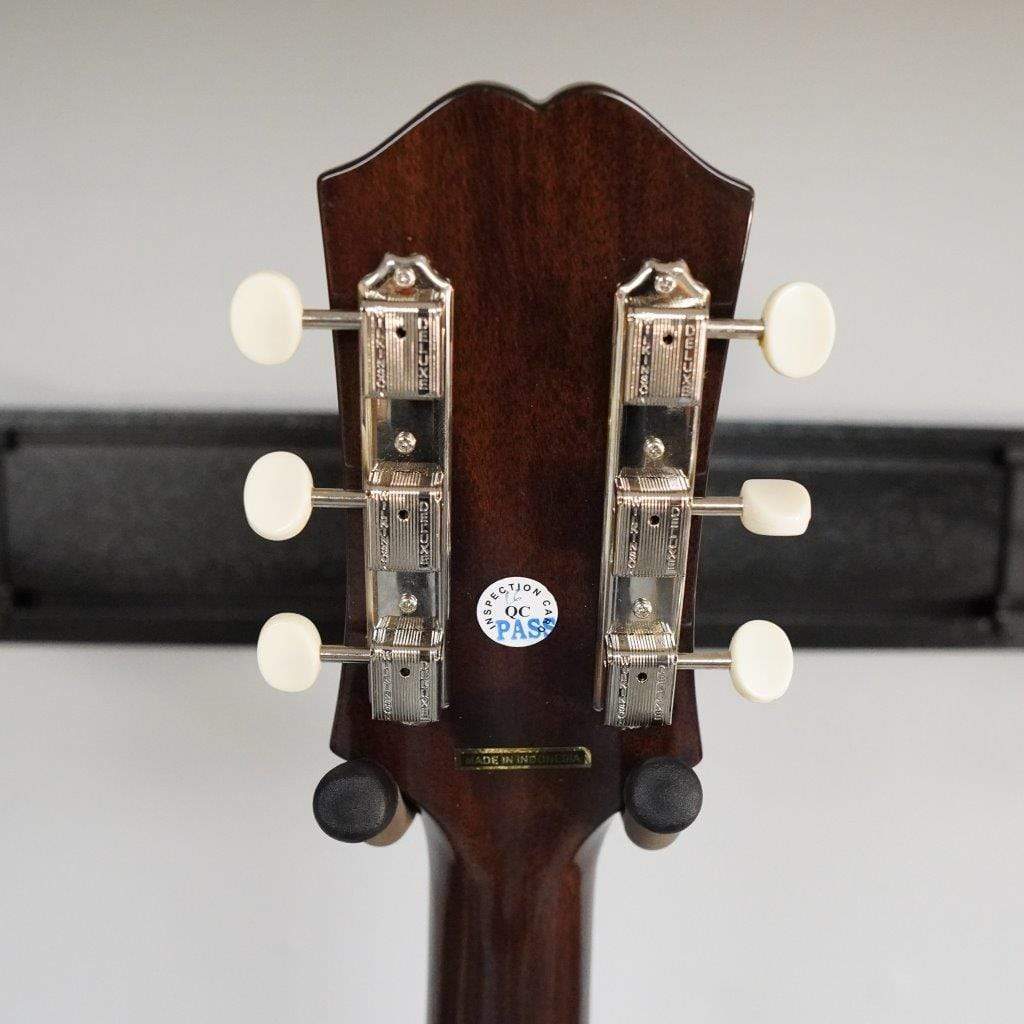Epiphone Masterbilt J-45 EC guitar's back showing solid mahogany, rounded C neck profile, with Fishman electronics visible.