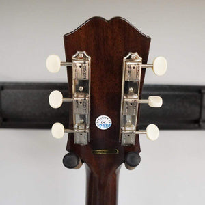 Epiphone Masterbilt J-45 EC guitar's back showing solid mahogany, rounded C neck profile, with Fishman electronics visible.