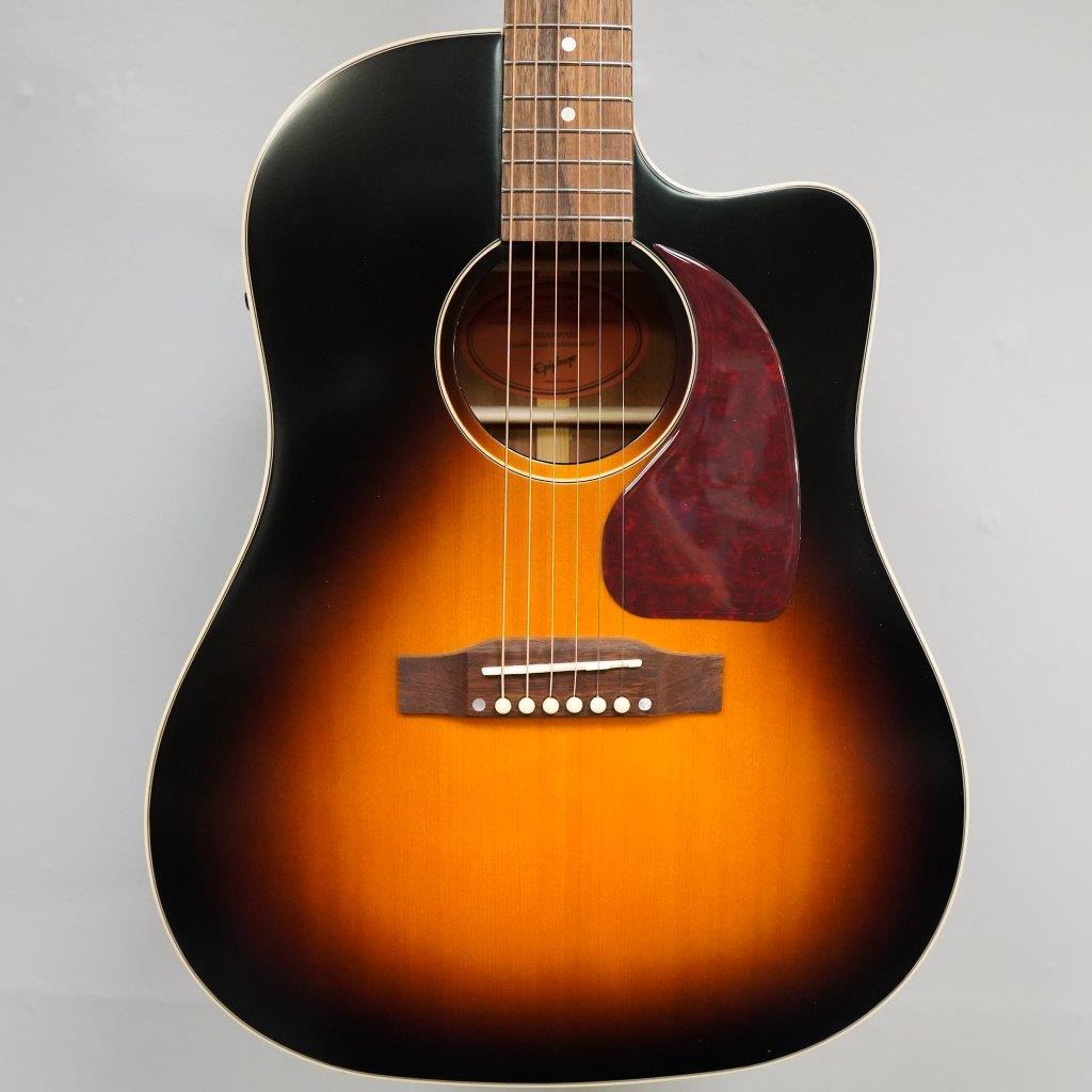 Epiphone Masterbilt J-45 EC Aged Vintage Sunburst Gloss guitar, showcasing its sloped shoulder body and intricate string details.