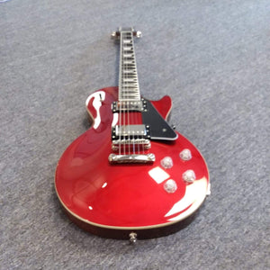 Red Epiphone Les Paul Modern electric guitar on a carpet, featuring a sleek design with contemporary updates like a slim taper neck and ProBucker™ pickups.