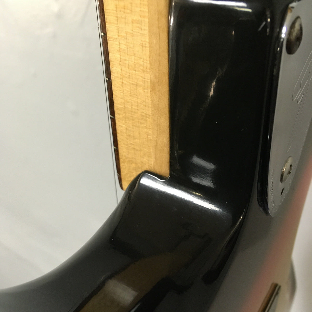 Close-up of a 1976 Fender Stratocaster guitar in Sunburst finish, all original, with included case and paperwork.