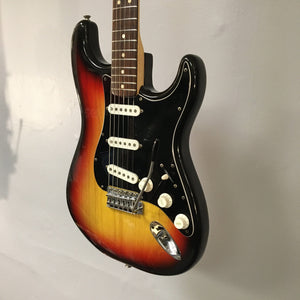 1976 Fender Strat Sunburst with original parts, paperwork, and case; features a close-up of knobs, strings, and neck detailing.