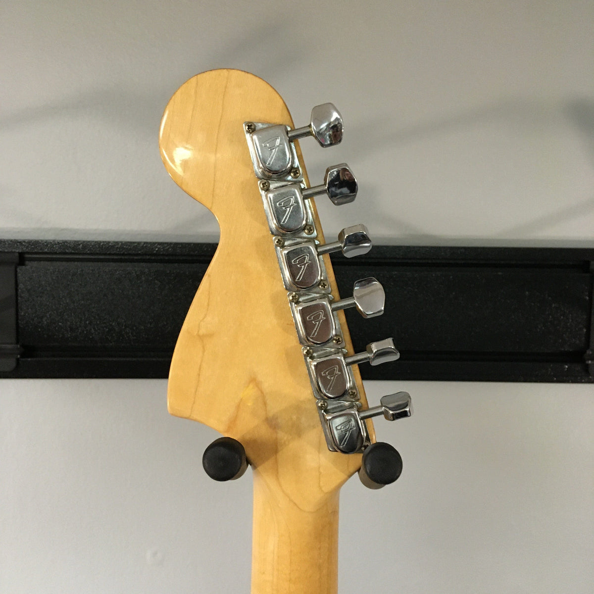1976 Fender Strat Sunburst, all original with case and paperwork, close-up of guitar neck and body, showcasing silver knobs and metal parts.