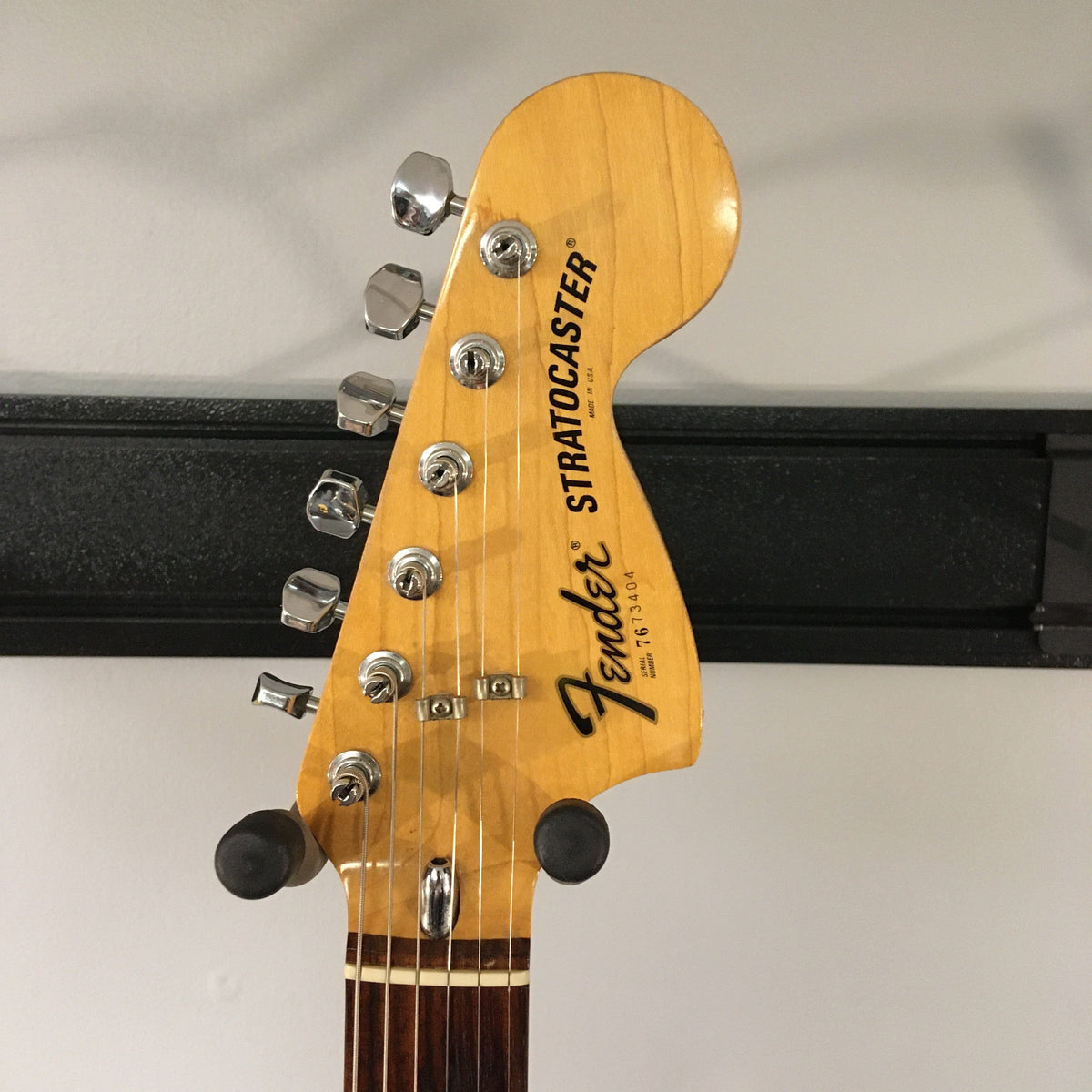 1976 Fender Stratocaster Sunburst, all original parts, close-up of guitar body and strings, includes original case and paperwork.