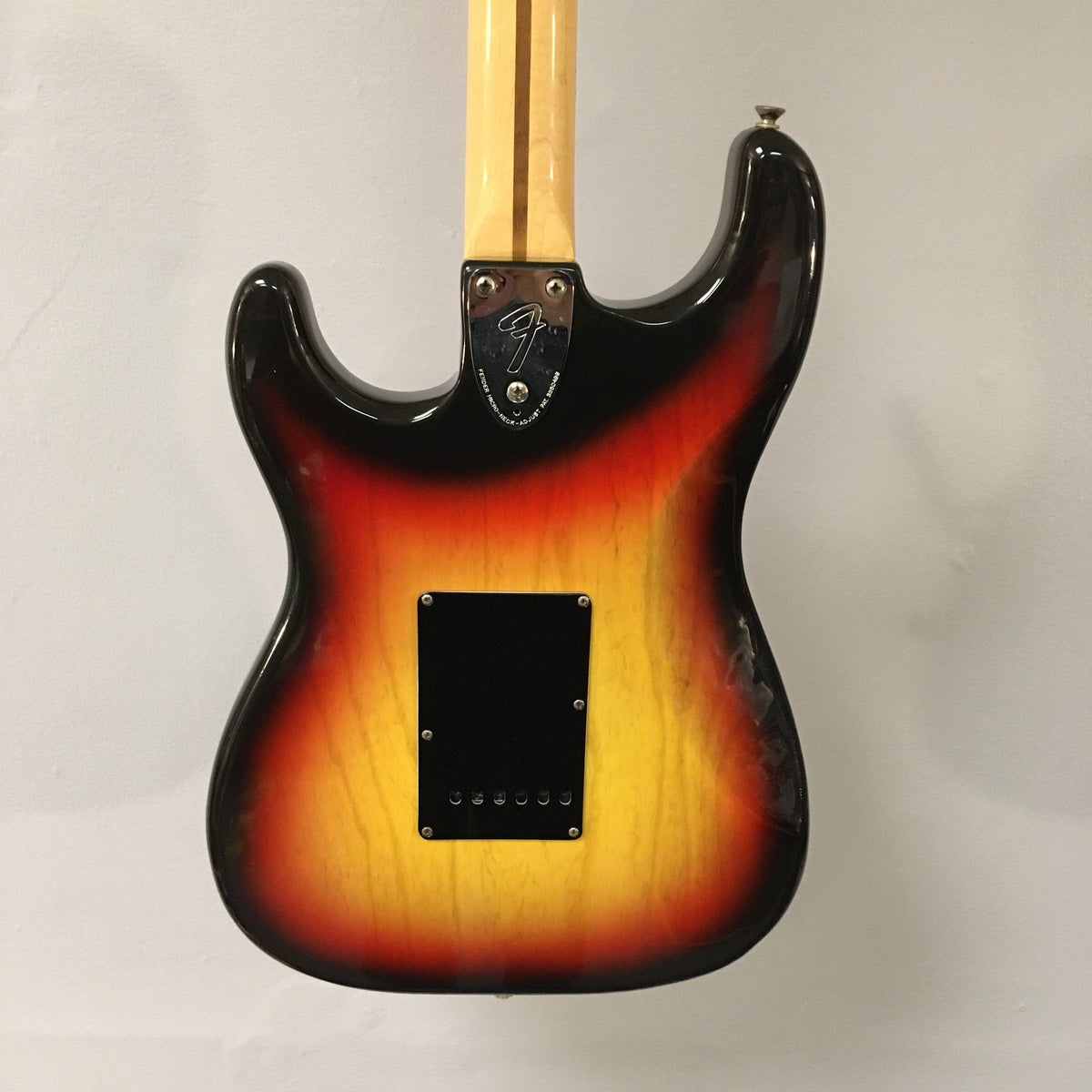 1976 Fender Stratocaster Sunburst, all original parts, close-up view. Includes original case, paperwork, tools, and tremolo bar. Great condition with minor wear.