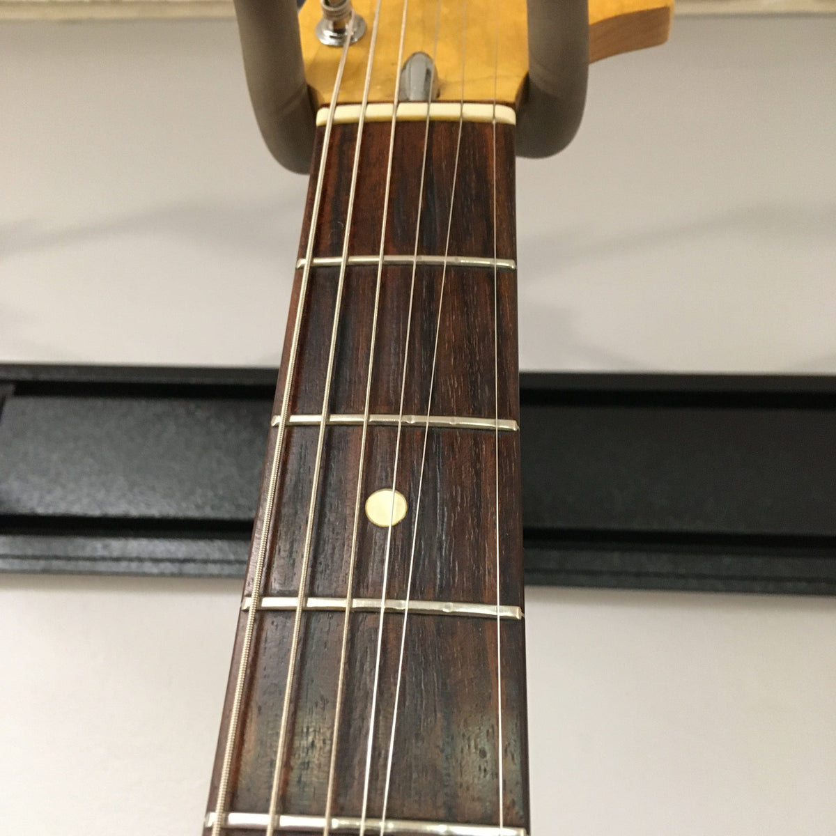 1976 Fender Stratocaster Sunburst, close-up of neck and strings, all original parts, with case and paperwork included.