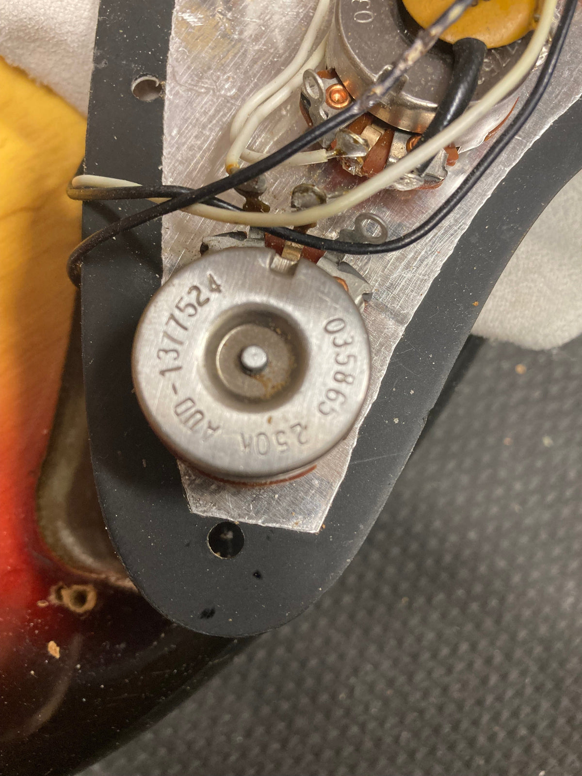 1976 Fender Stratocaster Sunburst with original parts, close-up on the metal bridge and wiring, showcasing its excellent vintage condition.
