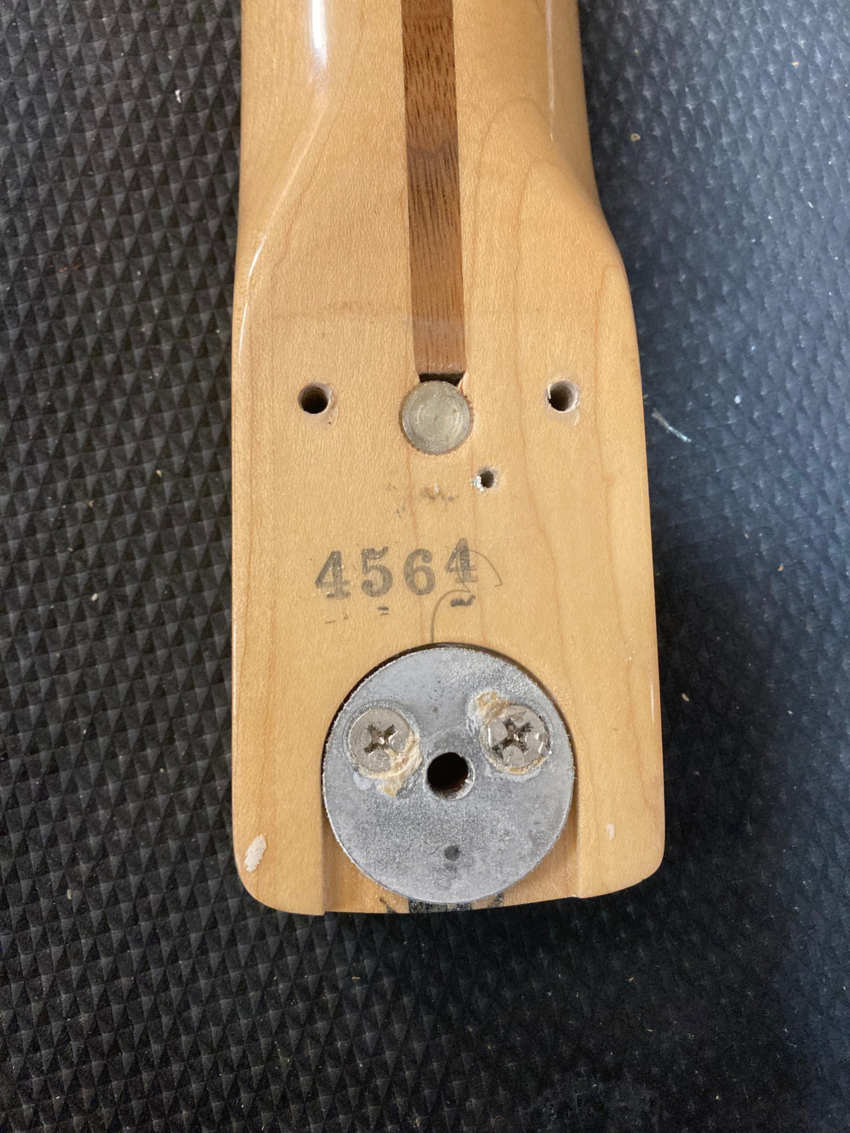 1976 Fender Stratocaster guitar with original parts, screws, and paperwork. Close-up shows wood grain and screws detail.