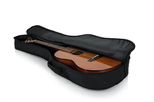Gator Mini Acoustic Guitar Gig Bag showcasing a guitar secured in a durable, padded, water-resistant case with an exterior storage pocket and reinforced support.