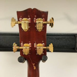 Close-up of a vintage Gibson EB-2C bass guitar, highlighting its worn, modified look and metal components. Available at Guitars on Main.