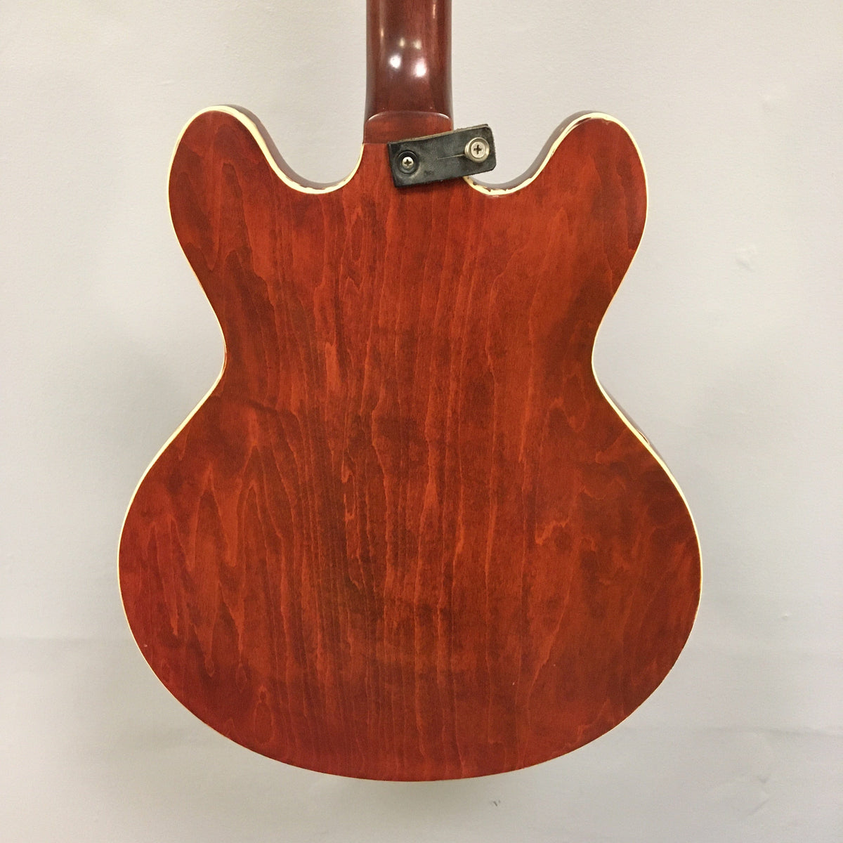Close-up of a vintage Gibson EB-2C bass guitar, highlighting its strings and craftsmanship. This used instrument dates back to 1958-1965.