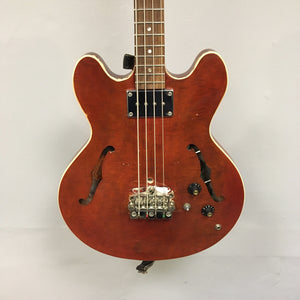 Close-up of a vintage Gibson EB-2C bass guitar, showing its well-worn condition and unique modifications.