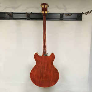 Gibson EB-2C 1958 to 1965? Bass Used hanging on a wall, showcasing its vintage design and modifications.