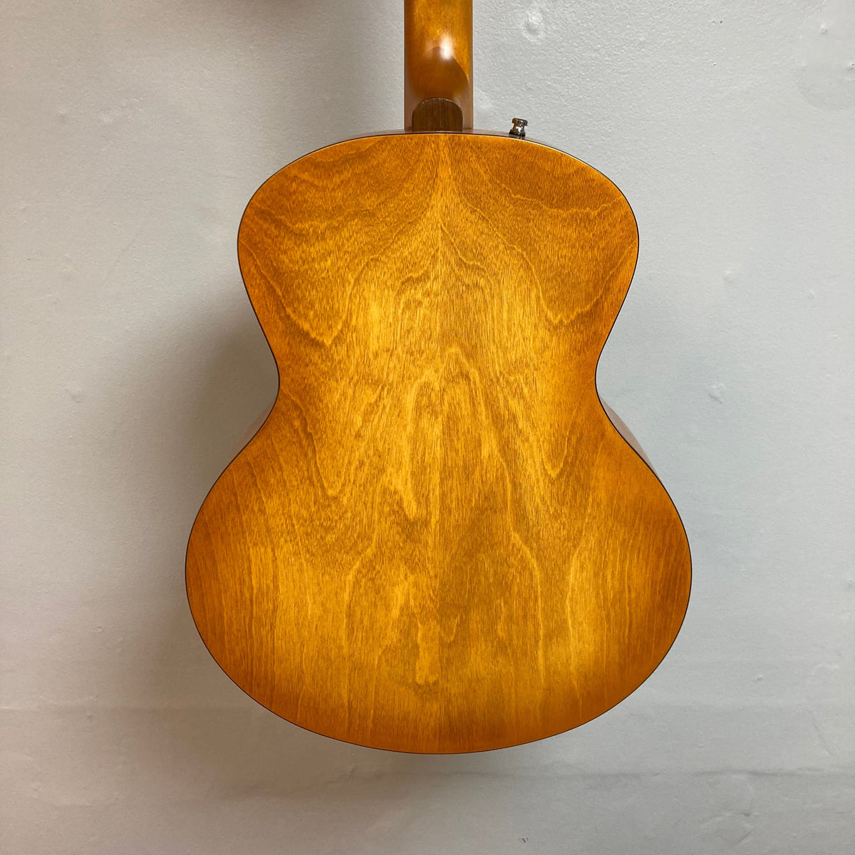 Godin 5th Avenue Jumbo P90 Harvest Gold guitar close-up, showcasing its Memphis Sun finish, redesigned headstock, large fret markers, and Godin logo.