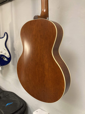 Godin 5th Avenue Kingpin P90 Cognac Burst archtop electric guitar, mounted on a wall, showcasing its polished finish and vintage design features.