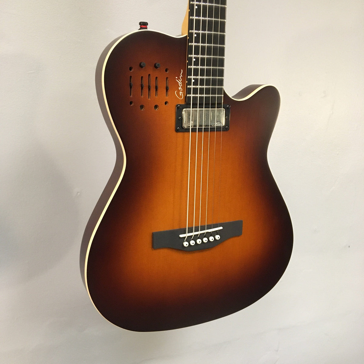 Godin A6 Ultra Baritone guitar with strings close-up, featuring a mini-humbucker and dual outputs for acoustic and electric play. Comes with a gig bag.