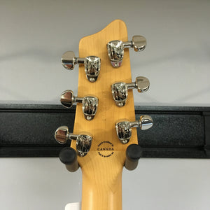 Close-up of the Godin A6 Ultra Baritone guitar head with silver knobs and logo.