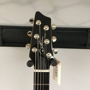 Godin A6 Ultra Baritone guitar with price tag and barcode visible.