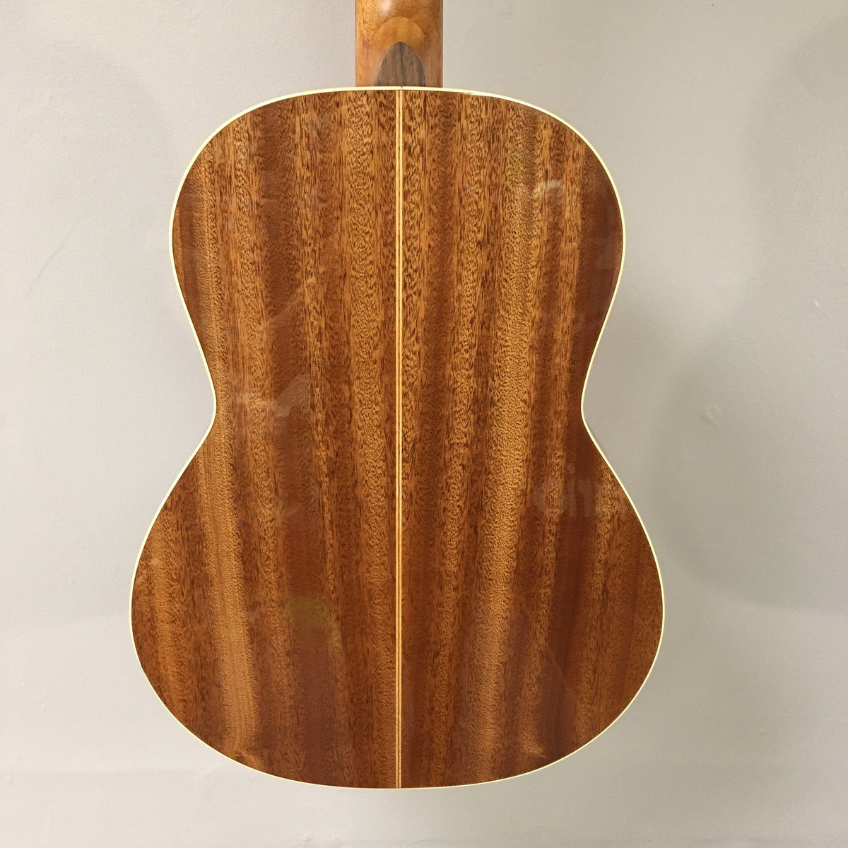 Close-up of the Godin Concert Nylon String Classical Guitar, highlighting the solid mahogany body, cedar top, and high gloss finish.