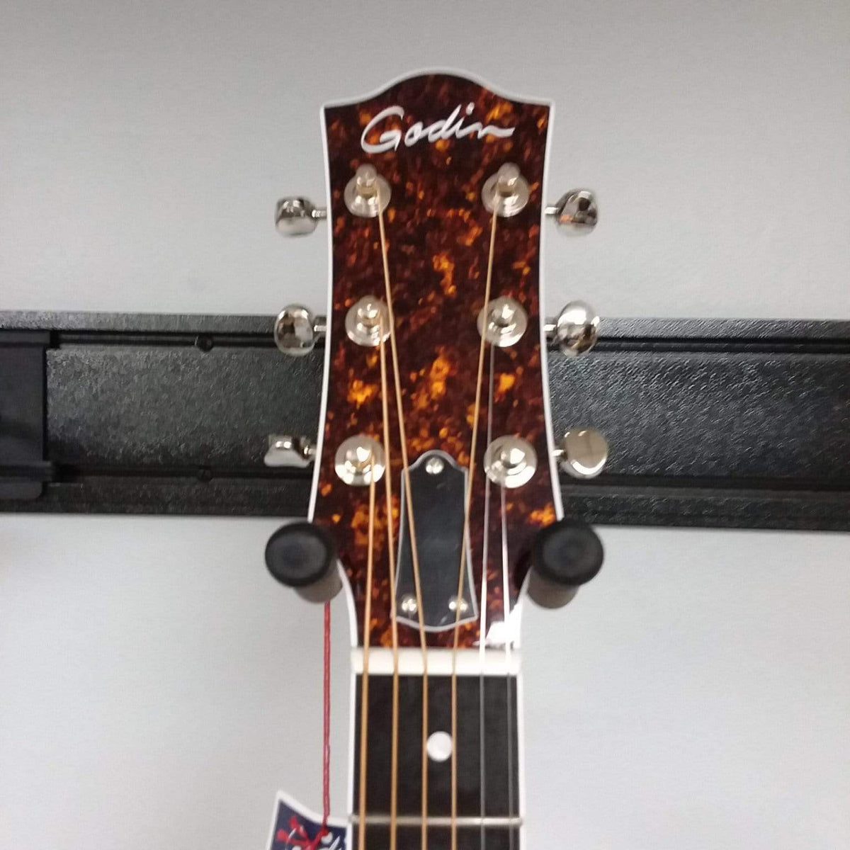Close-up view of the Godin Imperial Laguna Blue GT EQ guitar head and strings, highlighting the tuning pegs and craftsmanship.