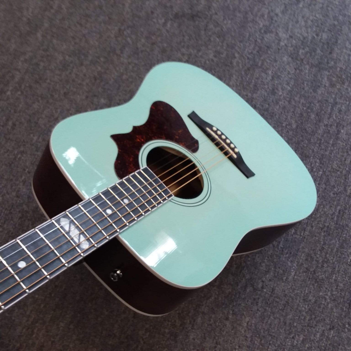 Godin Imperial Laguna Blue GT EQ acoustic guitar with mahogany back, Sitka spruce top, and LR Baggs Anthem system, displayed on the floor.