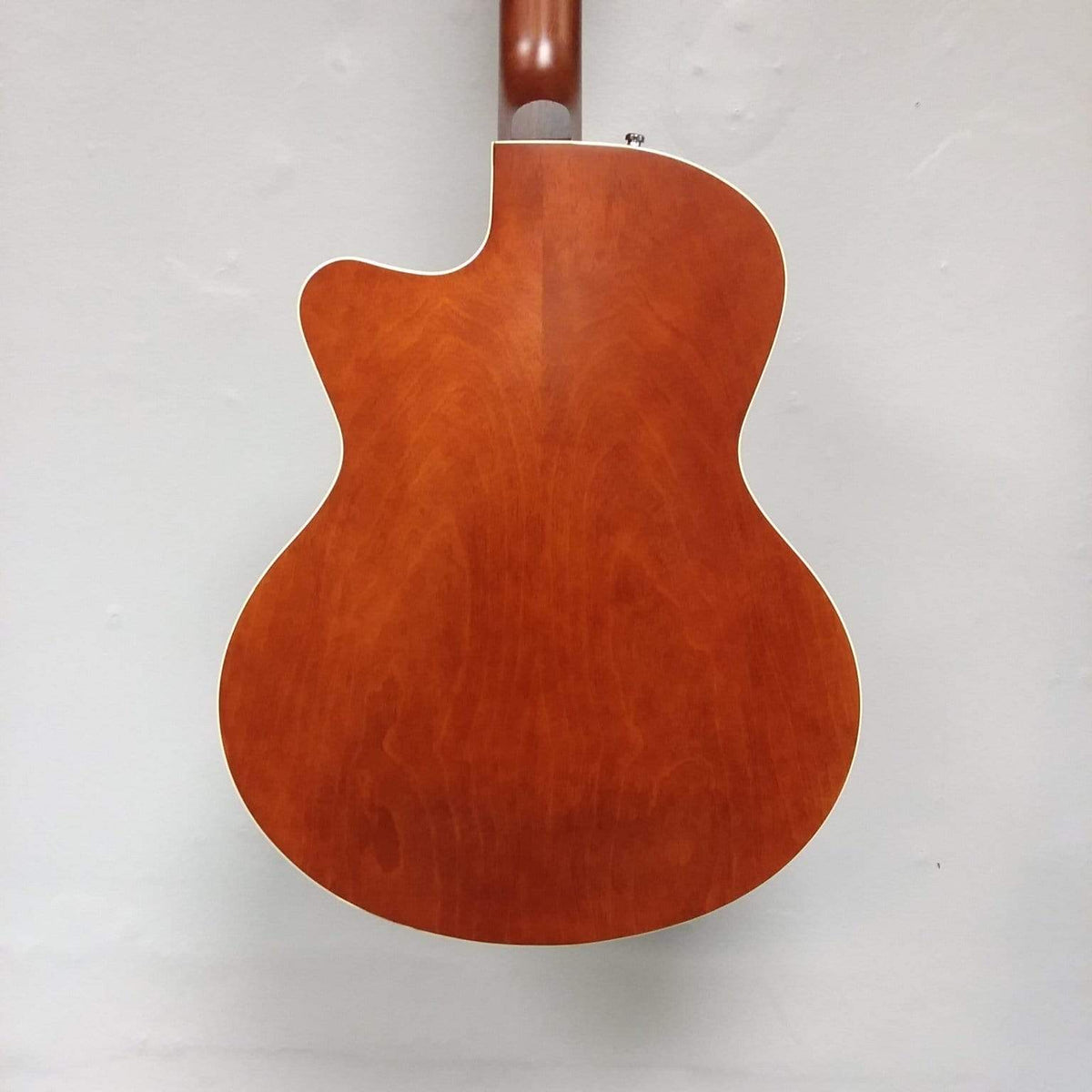 Godin 5th Avenue CW Kingpin II guitar with cutaway body and dual P90 pickups, displayed against a white wall.