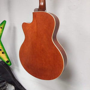 Godin 5th Avenue CW Kingpin II Cognac Burst guitar with vintage-style body and dual P90 pickups, mounted on a wall.
