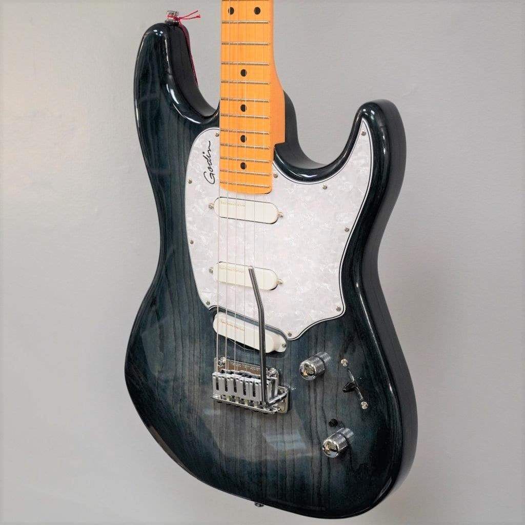 A close-up of a Godin RG3 Passion Lace Sensor Hot Gold electric guitar in Indigo Blue with a transparent finish, white pickguard, three Lace Sensor Hot Gold pickups, maple neck, two knobs, selector switch, and gig bag against a plain gray background.