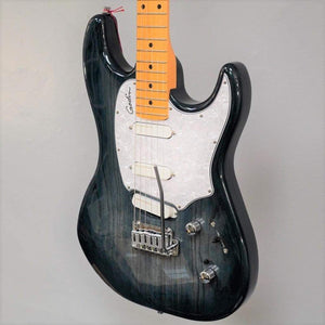 A close-up of a Godin RG3 Passion Lace Sensor Hot Gold electric guitar in Indigo Blue with a transparent finish, white pickguard, three Lace Sensor Hot Gold pickups, maple neck, two knobs, selector switch, and gig bag against a plain gray background.