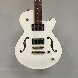 Godin Montreal Premiere HT Trans White guitar with white body, brown strings, black accents, and a Hard-tail bridge.