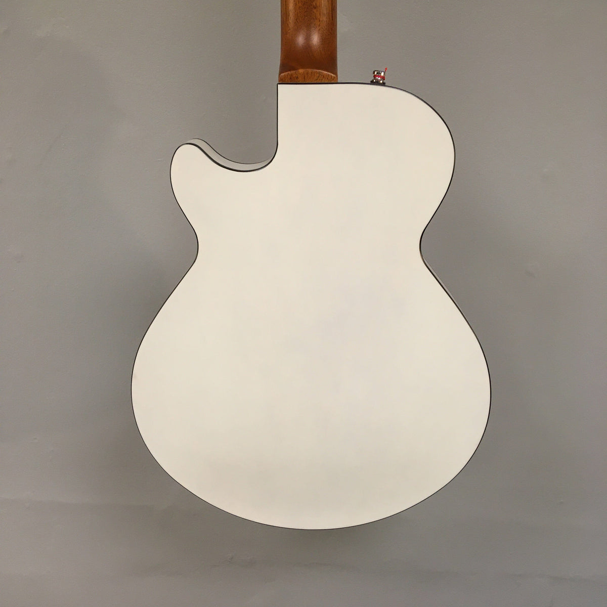 Godin Montreal Premiere HT Trans White guitar with white body, brown neck, and Hard-tail bridge.