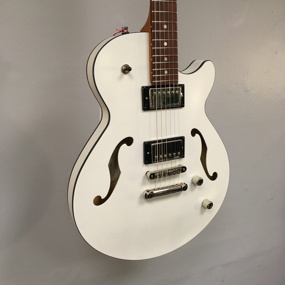 Godin Montreal Premiere HT Trans White guitar, semi-gloss finish, white body, brown neck, Hard-tail bridge, visible strings and pickups.