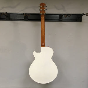 Godin Montreal Premiere HT Trans White Open Box guitar displayed on a wall, featuring a semi-gloss finish and hard-tail bridge.