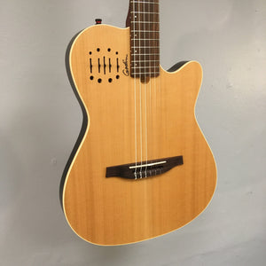 Close-up of Godin Multiac Nylon Encore SG SF guitar's strings and body, highlighting finish blemishes and detailed craftsmanship.