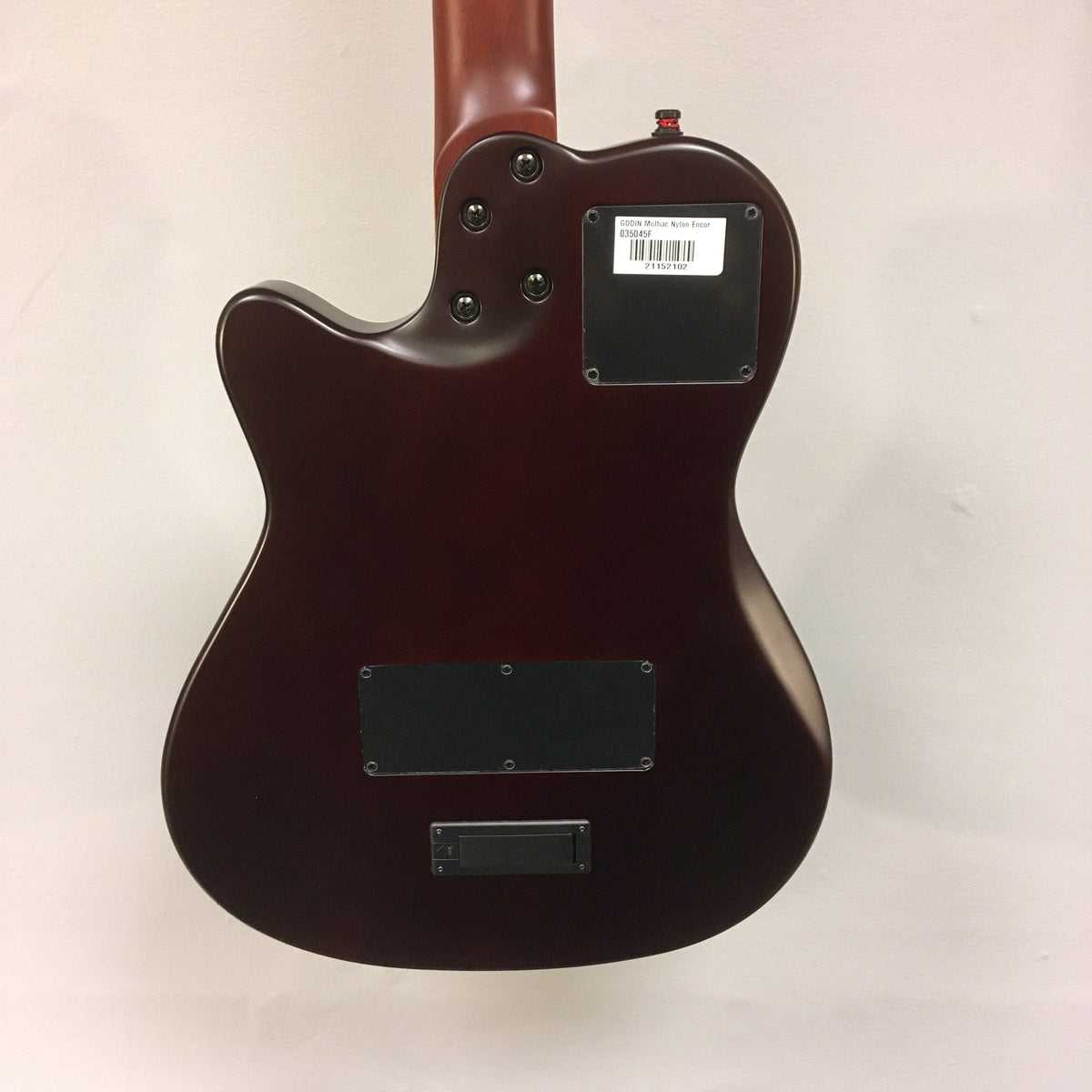 Close-up of the Godin Multiac Nylon Encore SG SF w/gigbag, highlighting its nylon strings, cedar top, and custom electronics.