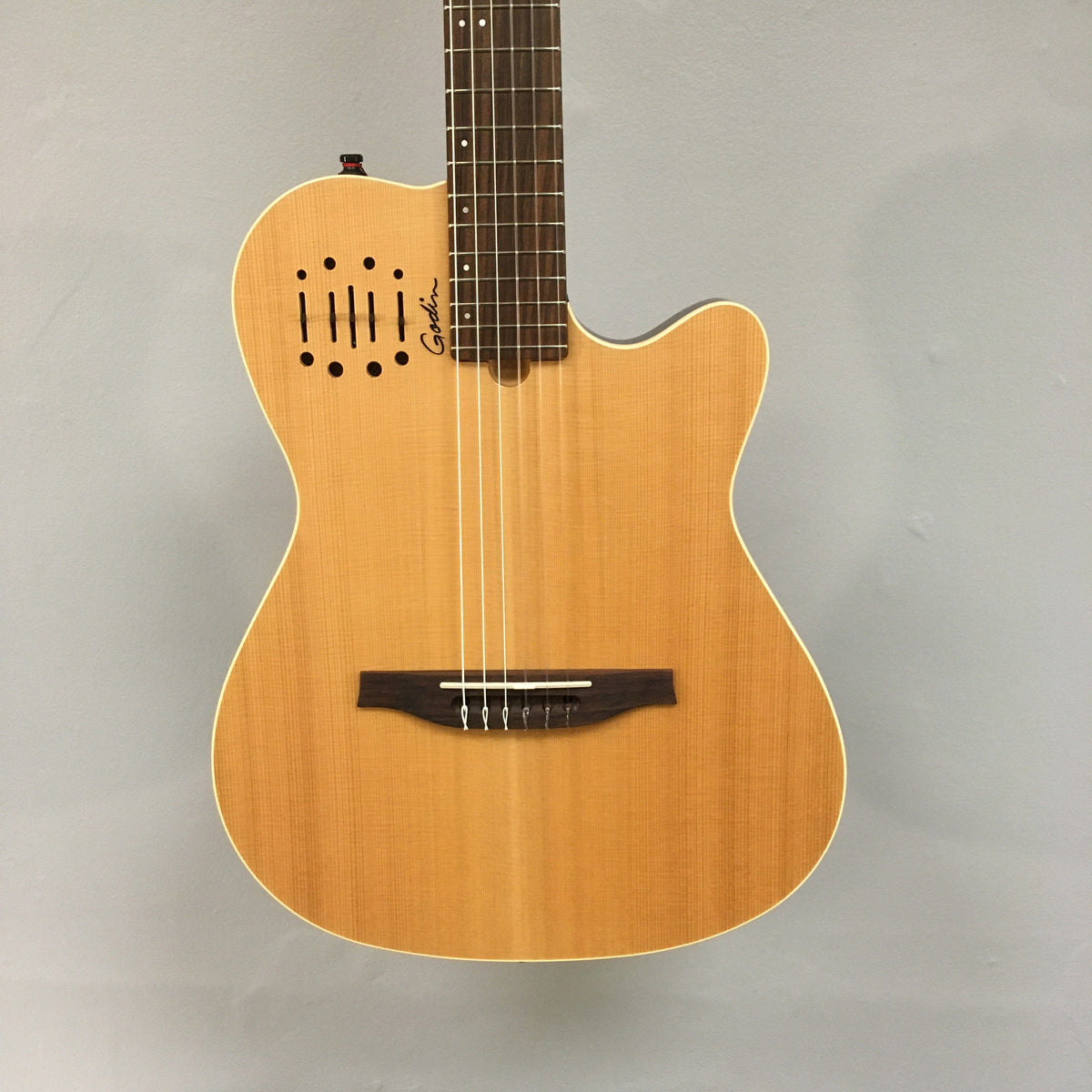 Close-up of the Godin Multiac Nylon Encore SG SF guitar strings and neck, highlighting the craftsmanship and detailing of this high-quality musical instrument.