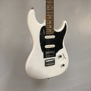 Godin Session HT Trans Cream RN displayed on a wall, showcasing its solid-body design, hardtail bridge, and H-S-S pickup configuration.