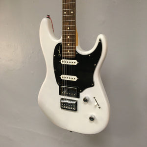 Godin Session HT Trans Cream RN electric guitar with a hardtail bridge and H-S-S pickup configuration hanging on a wall.