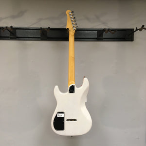 Godin Session HT Trans Cream RN electric guitar with a yellow handle, featuring a hardtail bridge and H-S-S pickup configuration, displayed on a wall.