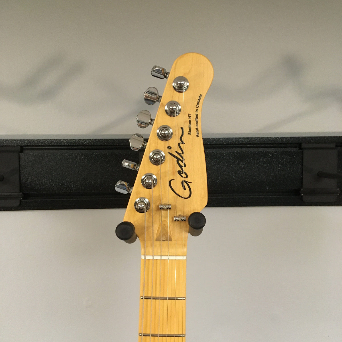Close-up of the Godin Stadium HT Matte Black guitar neck, showcasing the knobs and pegs.