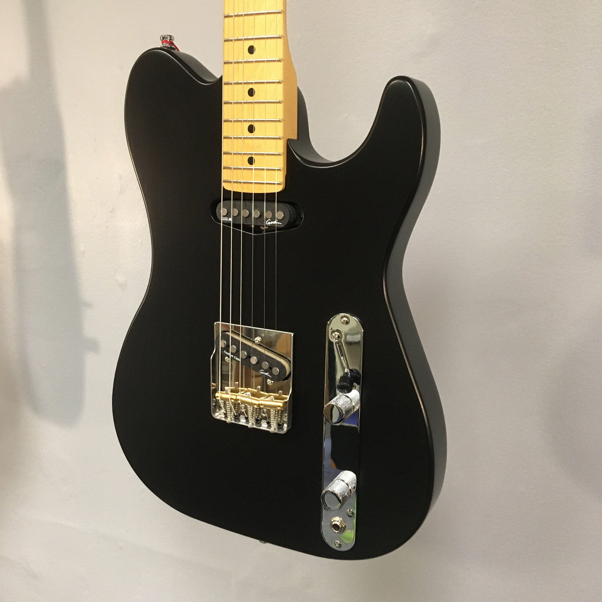 Godin Stadium HT Matte Black MN electric guitar with gold hardware, featuring a Hard Rock Maple Neck and Custom T-Ashtray Hardtail Bridge.