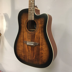 Luna Art Vintage Dreadnought Acoustic/Electric Guitar hanging on a wall, showcasing its brushed nickel tuners and solid spruce top.
