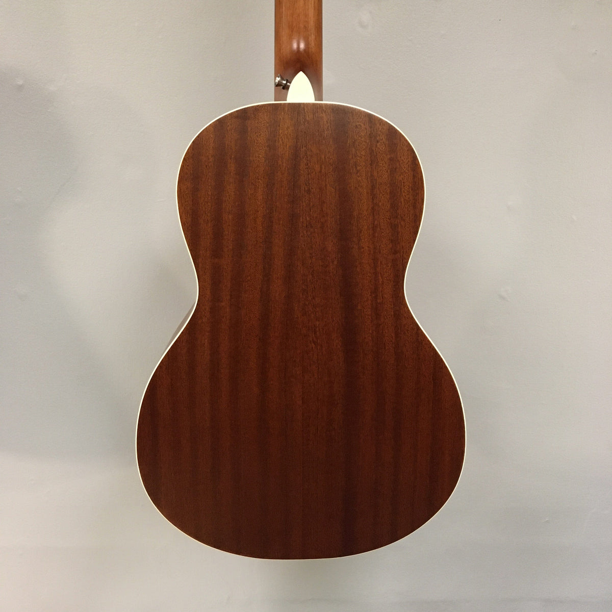 Luna Art Vintage Parlor guitar with distressed vintage brownburst finish, showcasing its mahogany body, select spruce top, and open gear tuners.