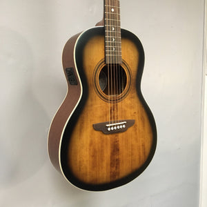 Luna Art Vintage Parlor Solid Top Distressed Vintage Brownburst guitar displayed on a wall, highlighting its detailed craftsmanship and rustic finish.