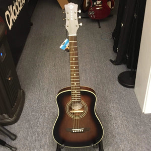 Luna Safari Artist Vintage Travel Guitar w/ Gigbag on a stand, showcasing its mahogany body, spruce top, and pearl moon phase inlays.