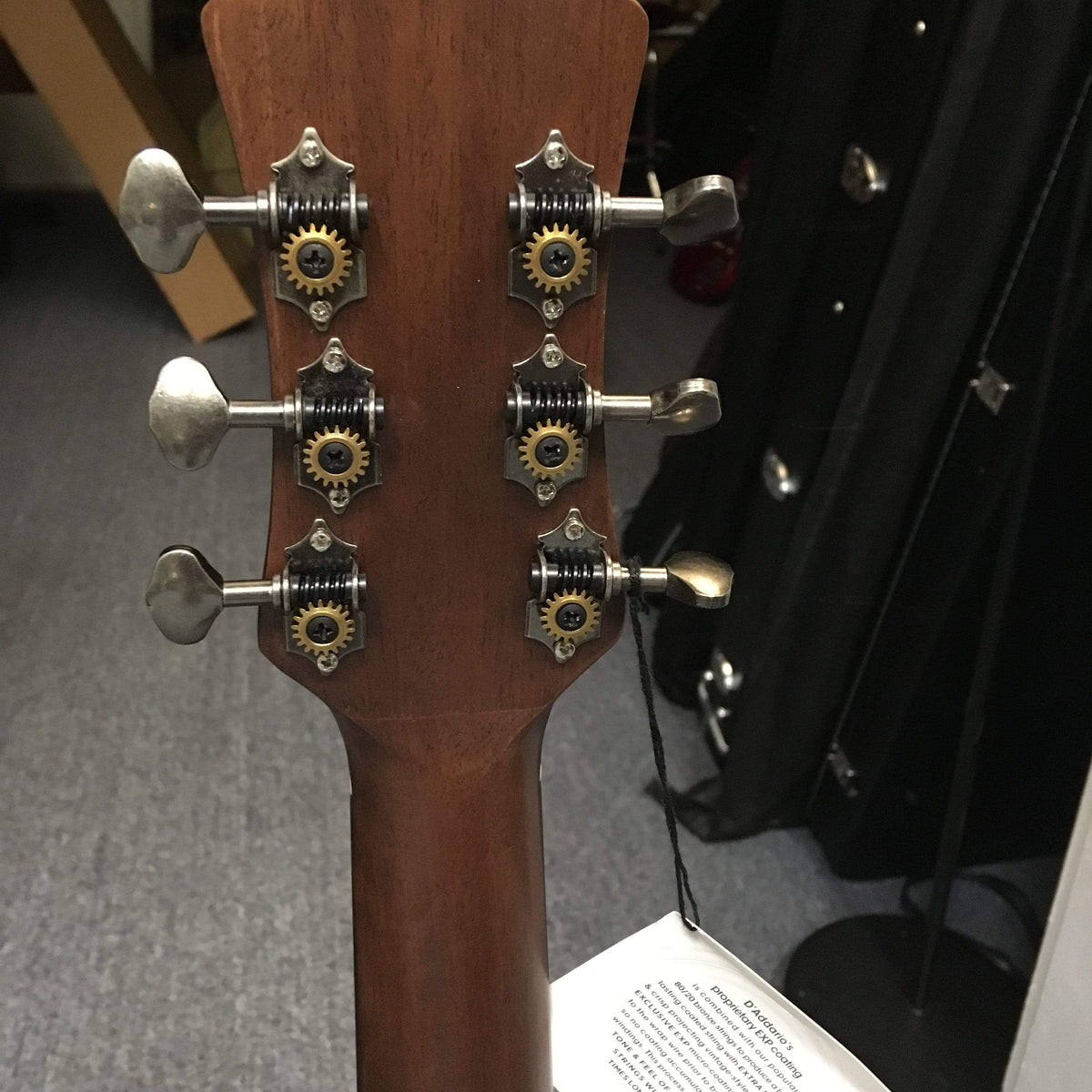 Close-up of Luna Safari Artist Vintage Travel Guitar showcasing its mahogany body, brushed nickel open gear tuners, and pearl moon phase inlays.