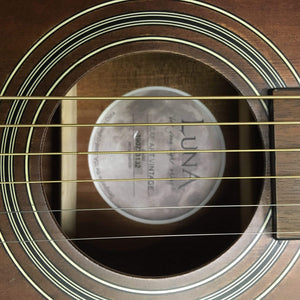 Close-up of Luna Safari Artist Vintage Travel Guitar strings and rosette design, highlighting craftsmanship and travel-friendly size.