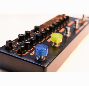 NUX NST-1 Pedal Topper, a black stomp switch cap with knobs and buttons, enhances pedalboard control for guitarists.