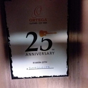 Ortega Nylon String Guitar R189SN-25TH with a black number 25 and a guitar image on a white sign.